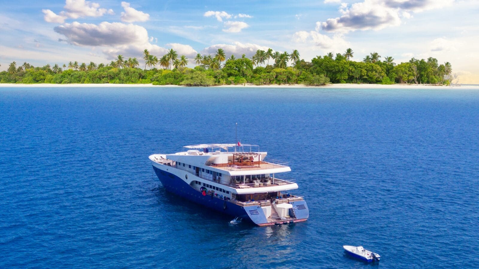 A boat in front of an island.