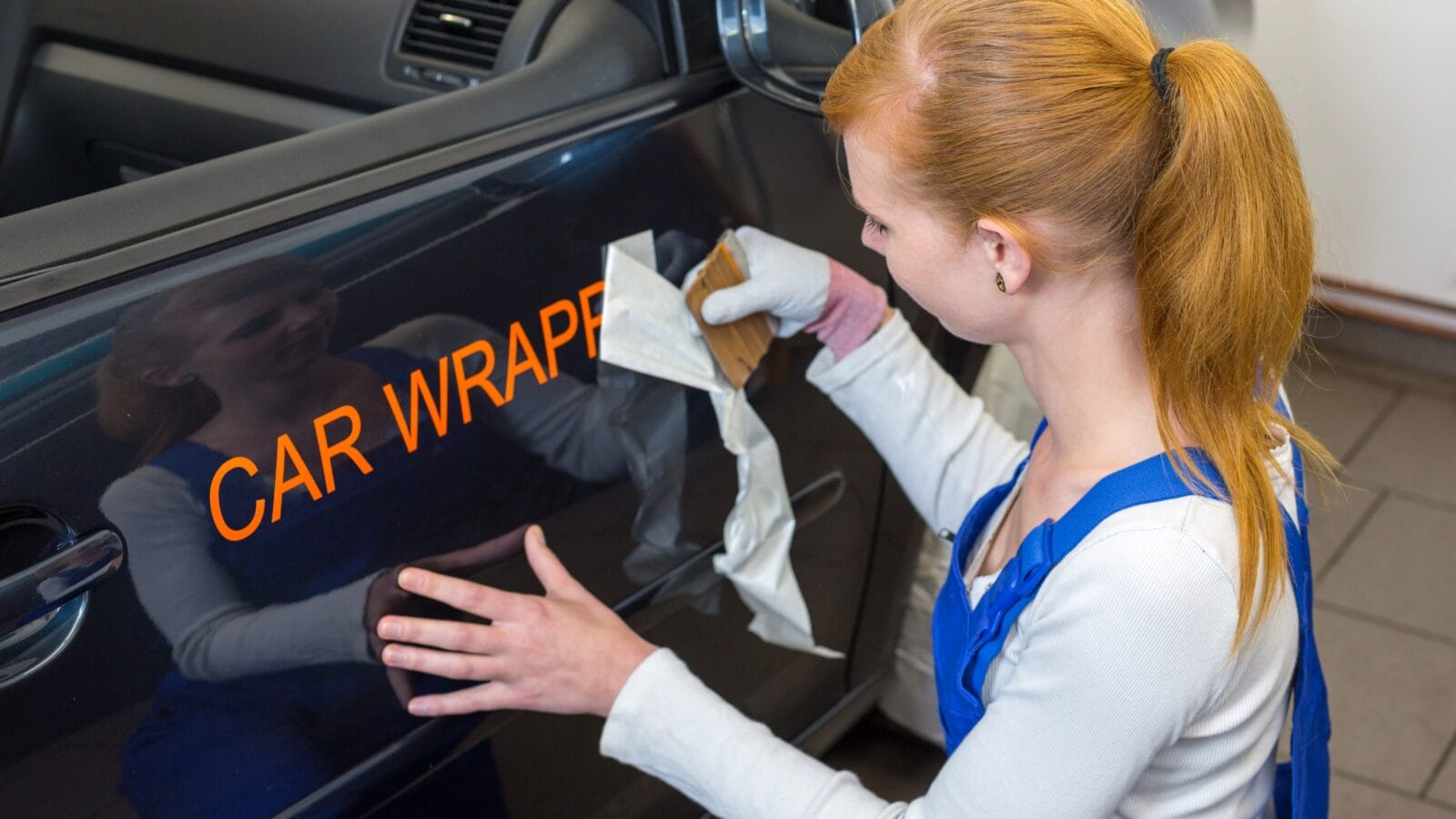 Person putting a label on a car