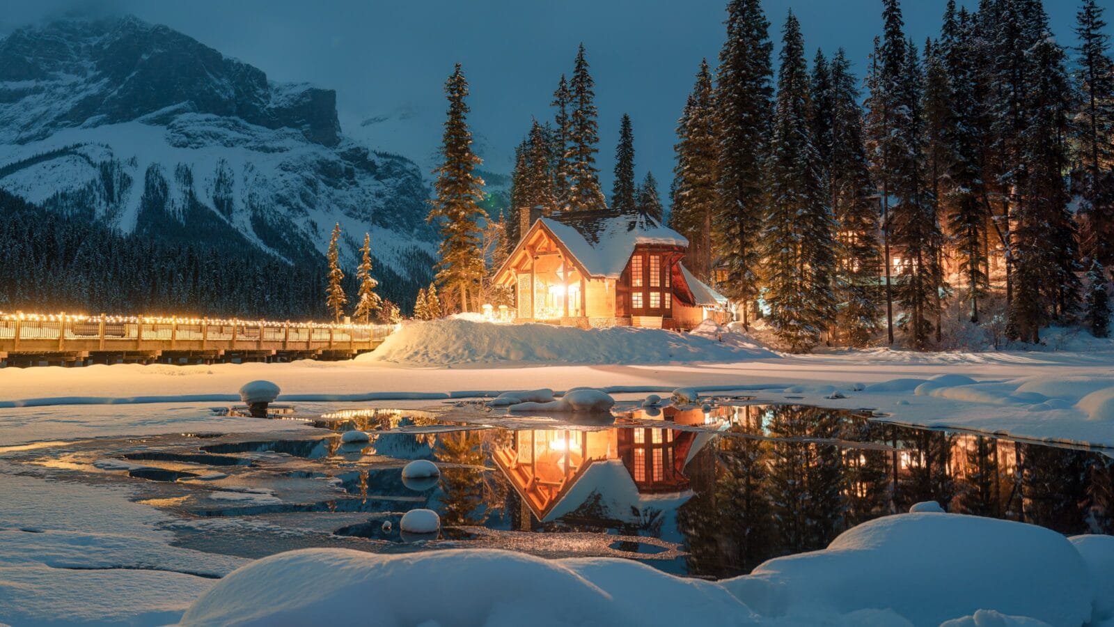 A cabin on a lake in winter.