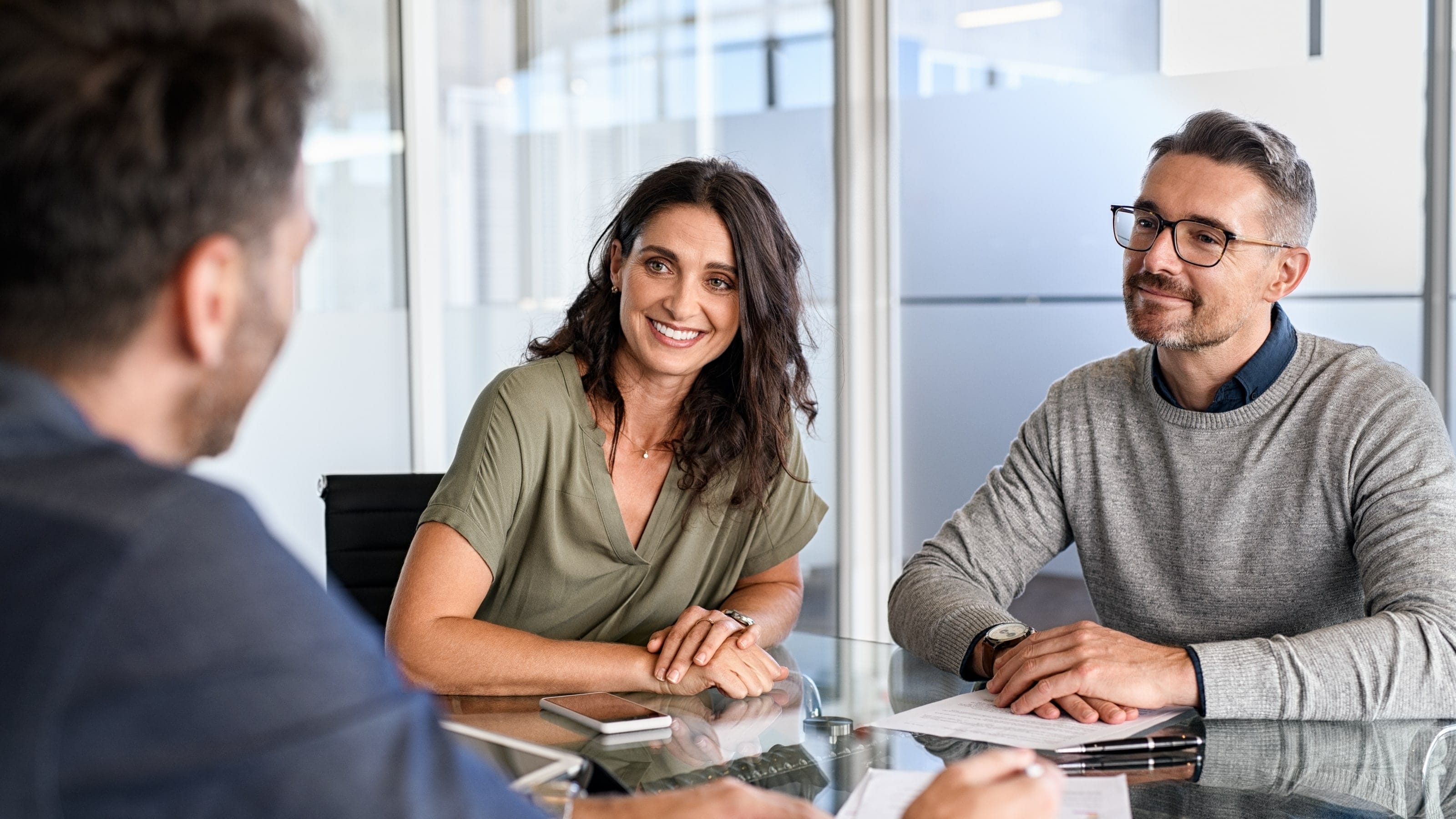 Couple talking to a bank manager.