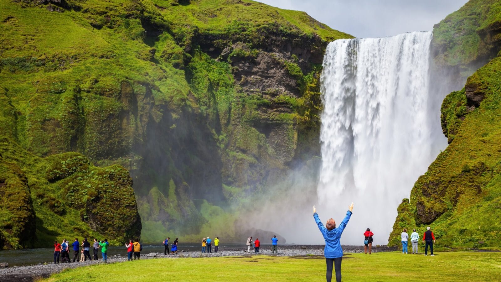 Person in front of a waterfall in Iceland.
