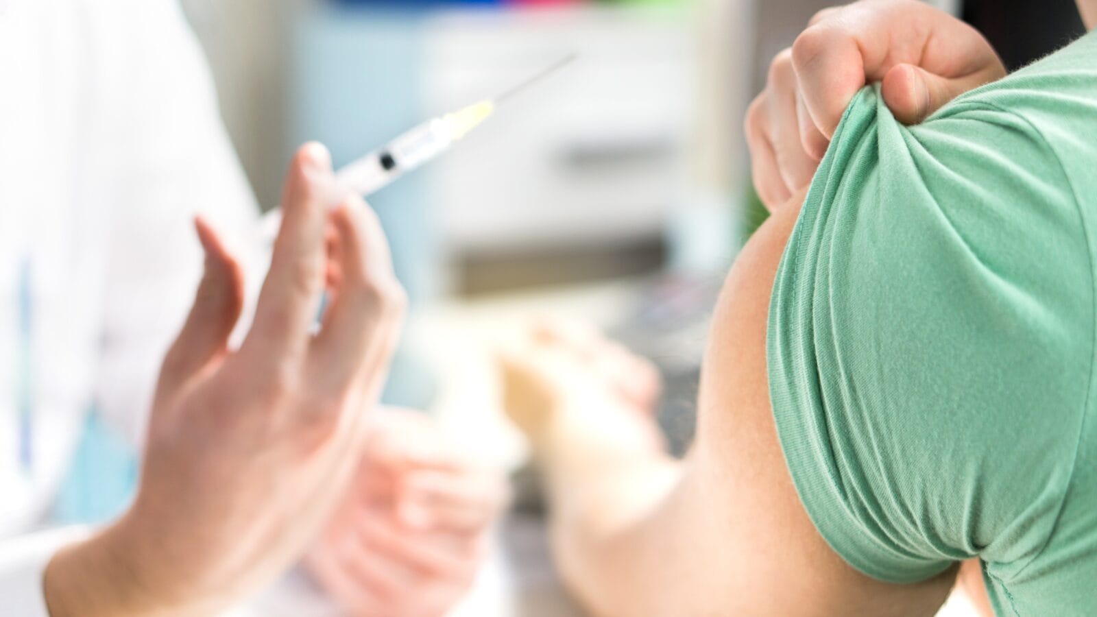 Doctor giving patient vaccine.