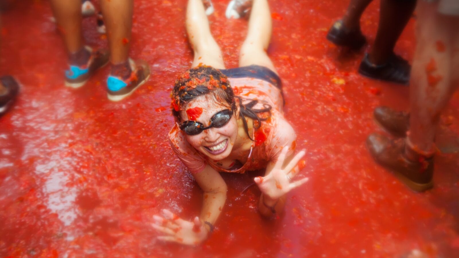 BUNOL, SPAIN - AUGUST 28: Unidentified girl in La Tomatina festival in August 28, 2013 in Bunol, Spain. La Tomatina festival where people are fighting with tomatoes at street