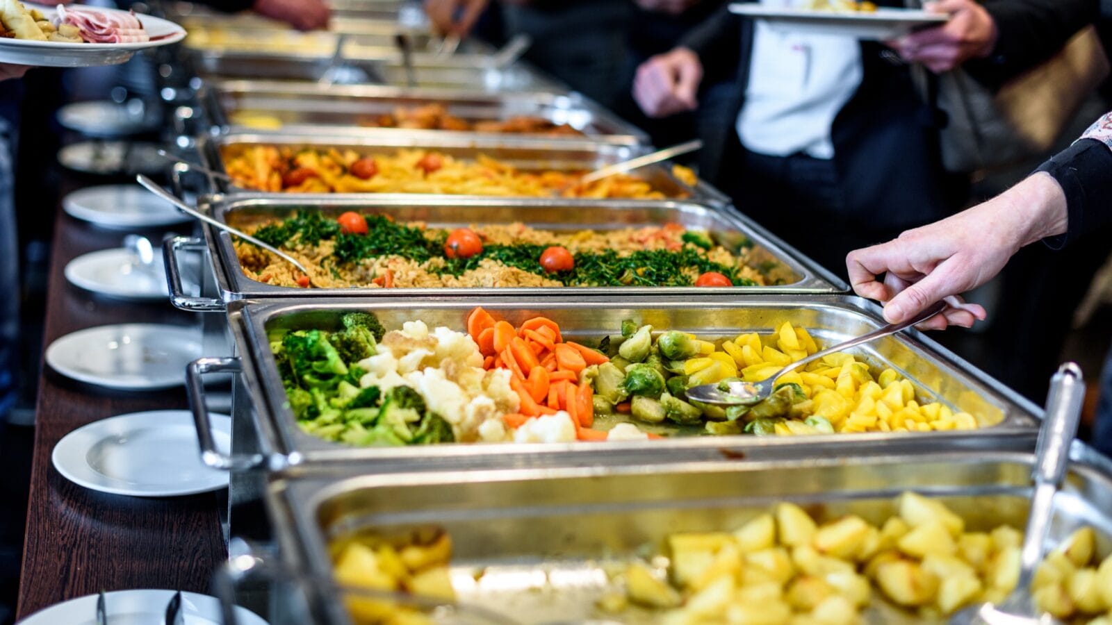 Group of people in all you can eat catering buffet food indoor in luxury restaurant.