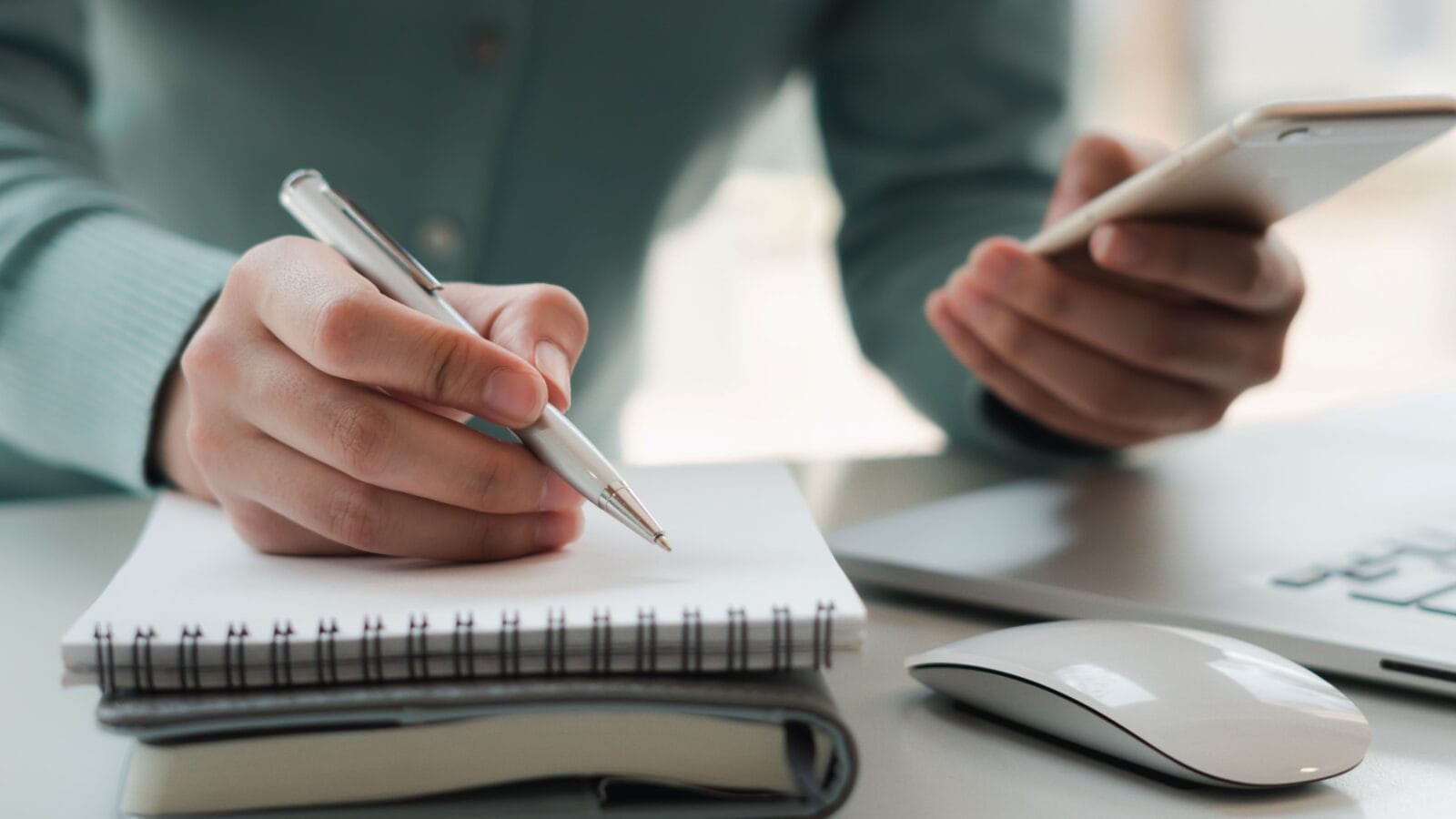 Businessmen use mobile phones and take notes