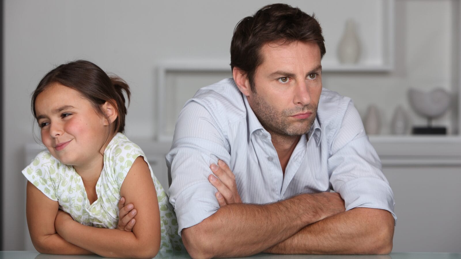A father and daughter sittting angry.