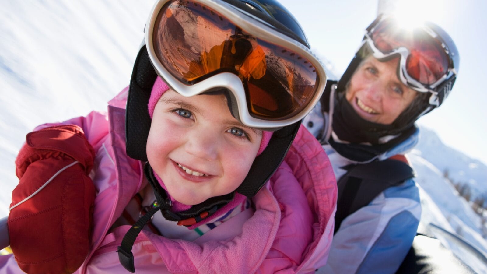 Young girl and grandmother on chair lift.