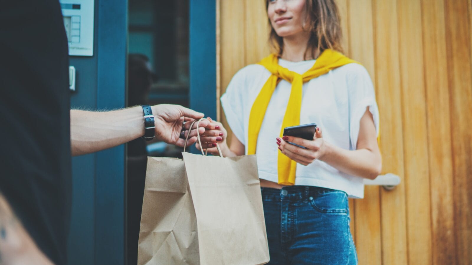 A courier delivering food to a girl.