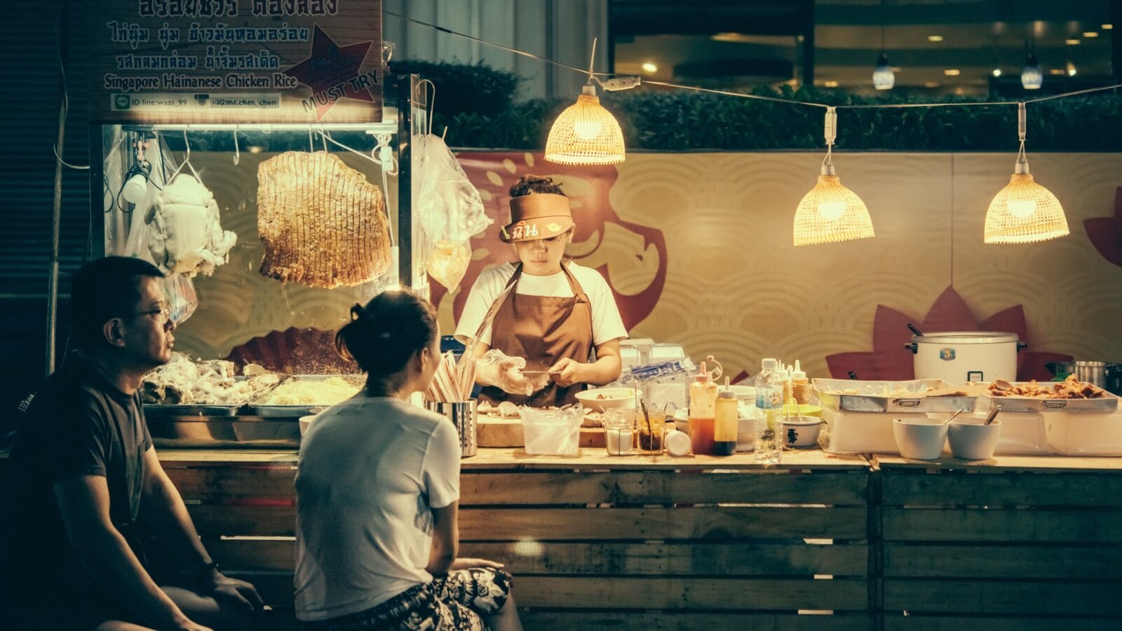People are buying food at night street food market in Bangkok