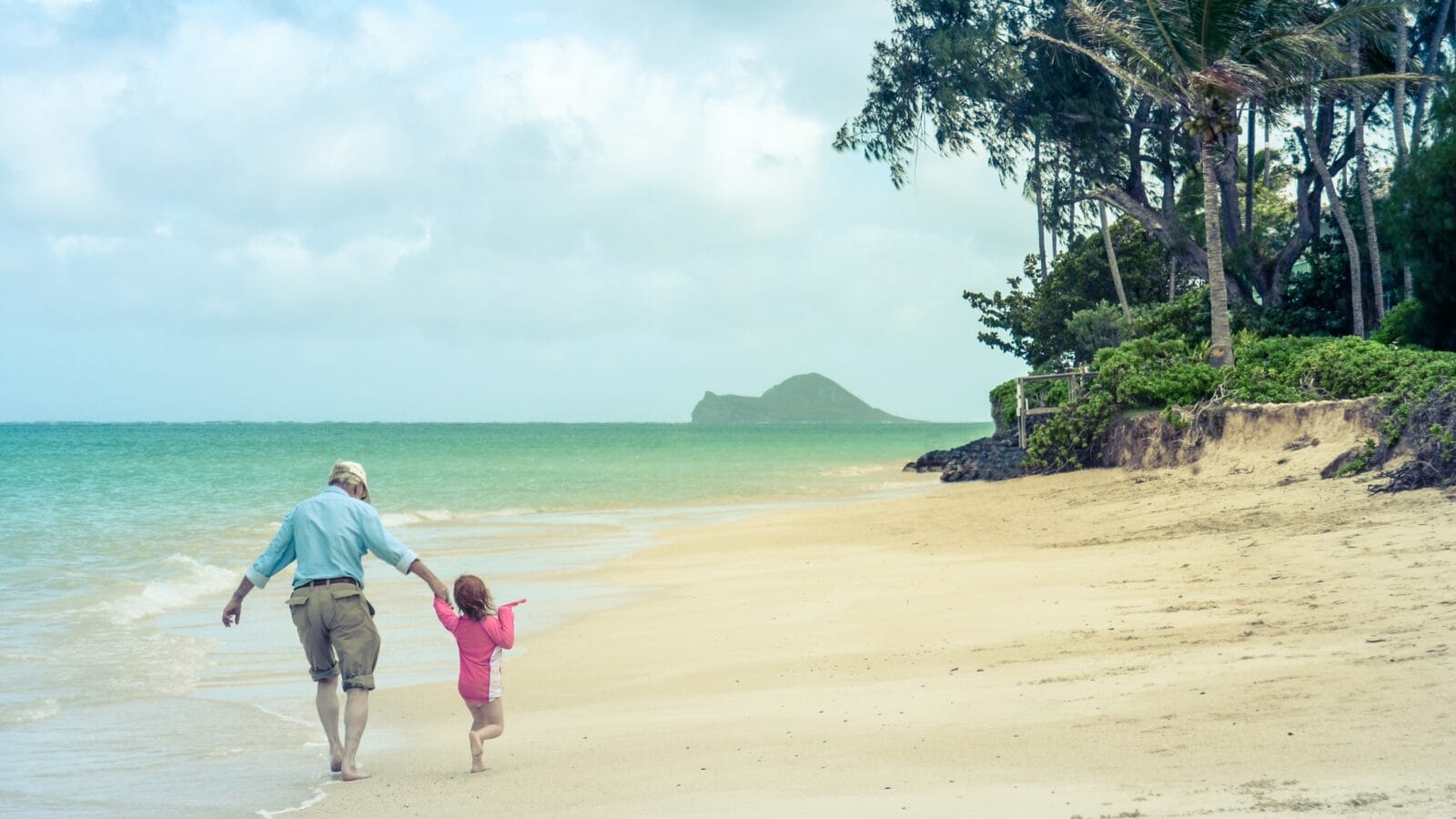A Girl With Her Grandad On A Tropical Beach