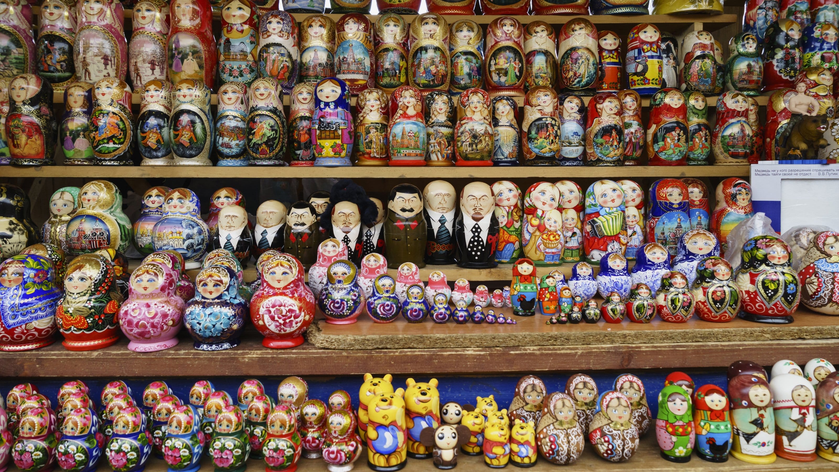 Various matryoshka dolls for sale on the shelf in a souvenir shop