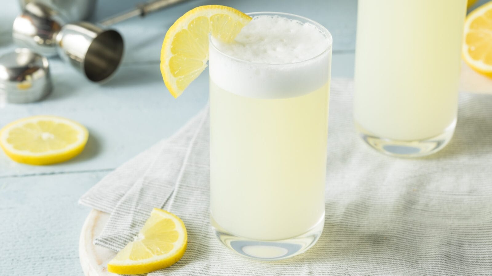 Refreshing Cold Egg Gin Fizz with a Lemon Garnish