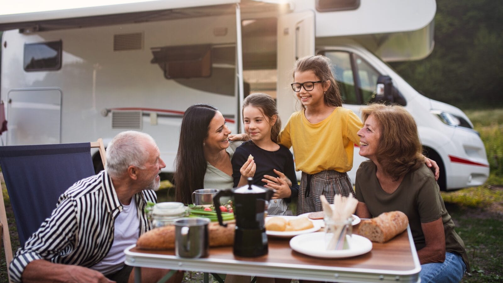 Grandparents with Grandchildren having fun camping.
