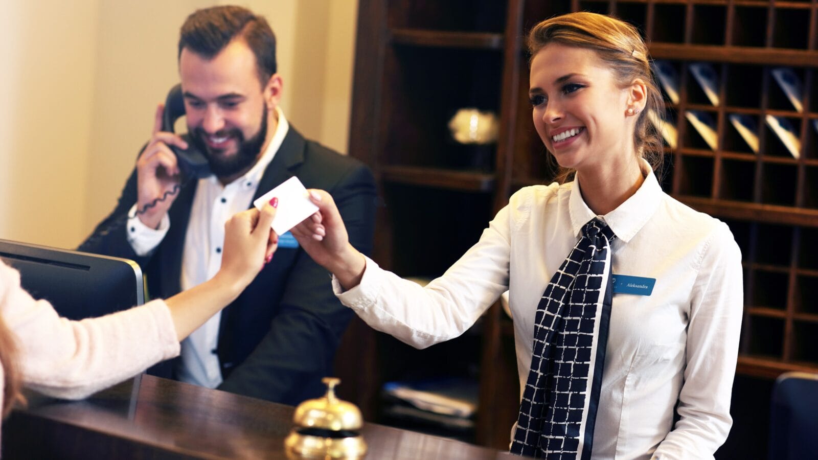 Picture of guests getting key card in hotel