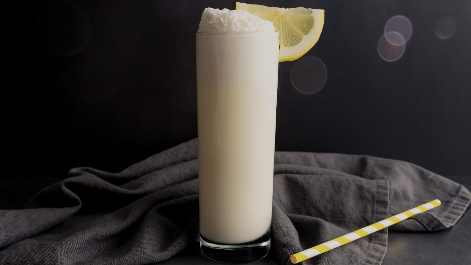 New Orleans Fizz gin cocktail with a sliced lemon garnish