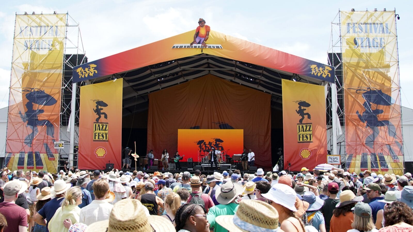 Crowds at the 2022 New Orleans Jazz and Heritage Festival on the "Festival Stage" dance.