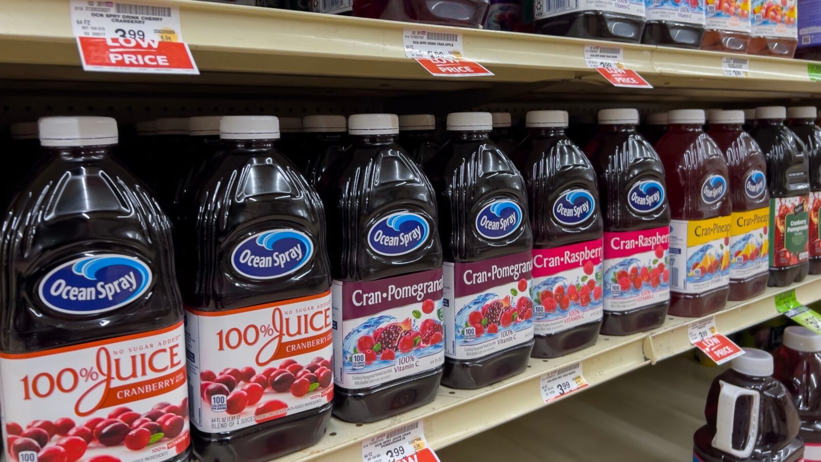Angled view of Ocean Spray juice products for sale inside a grocery store.