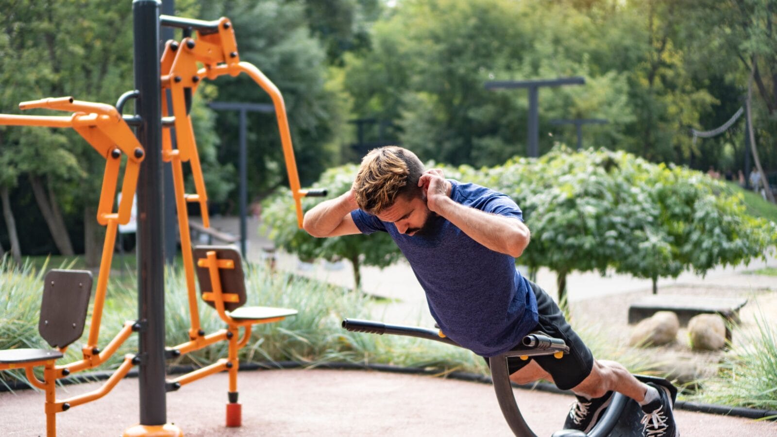 A man doing a workout outdoors.