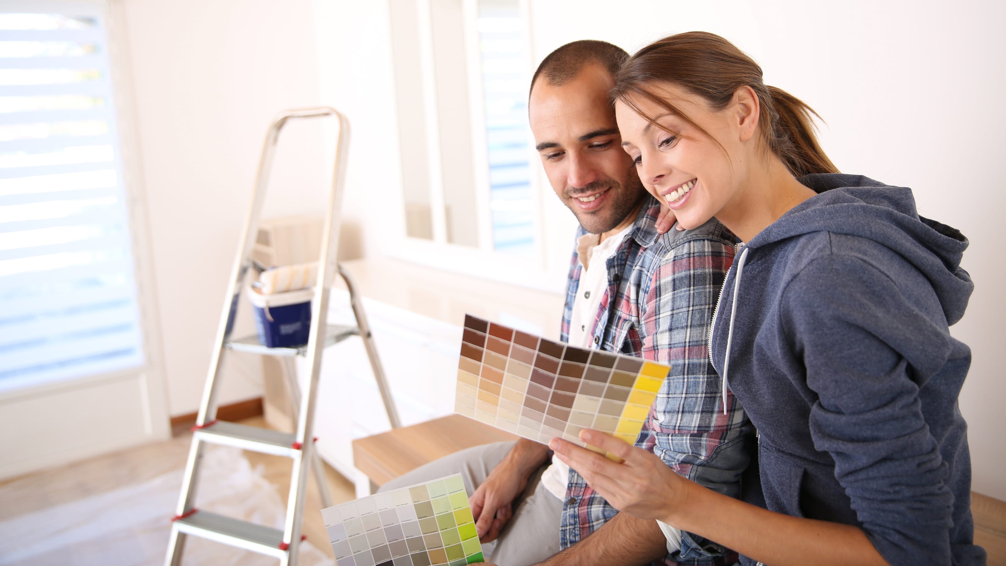 Couple in house choosing color for walls