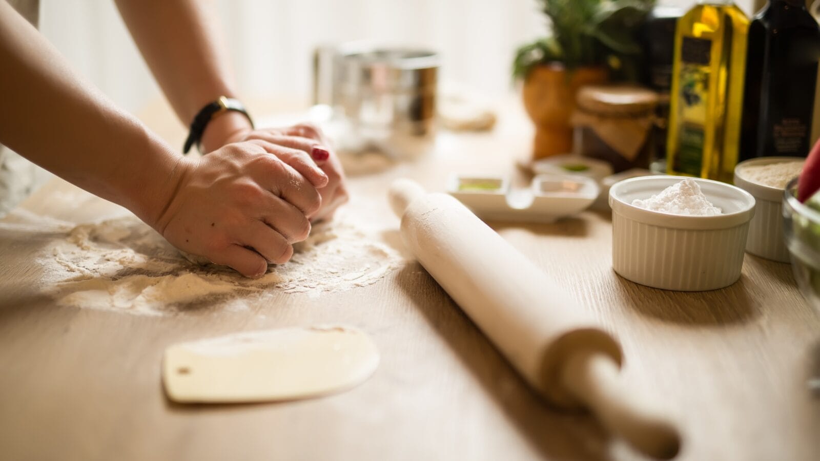 Woman kneading dough with her hands.