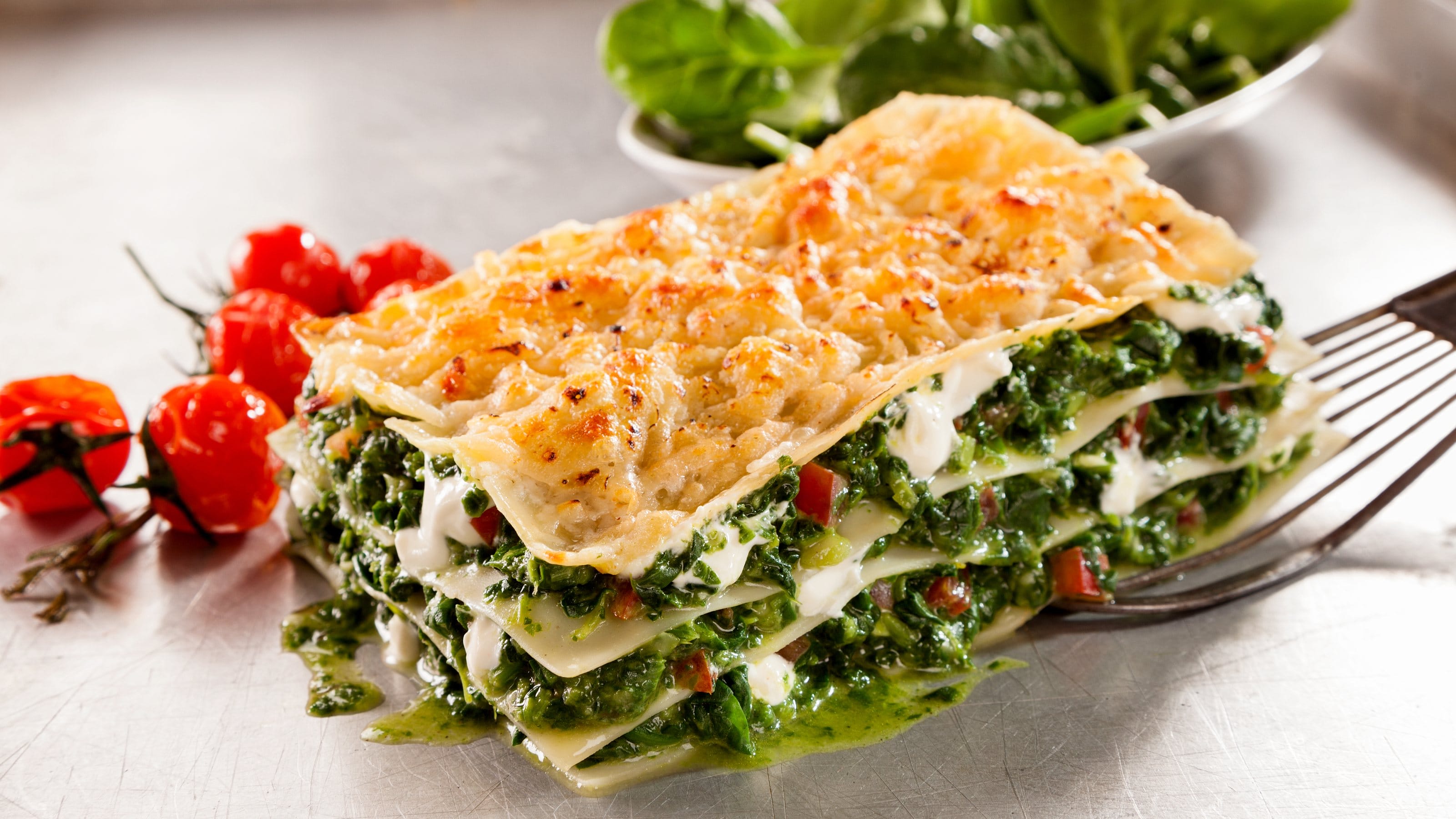 Healthy spinach and cheese Italian lasagne topped with crispy cheese