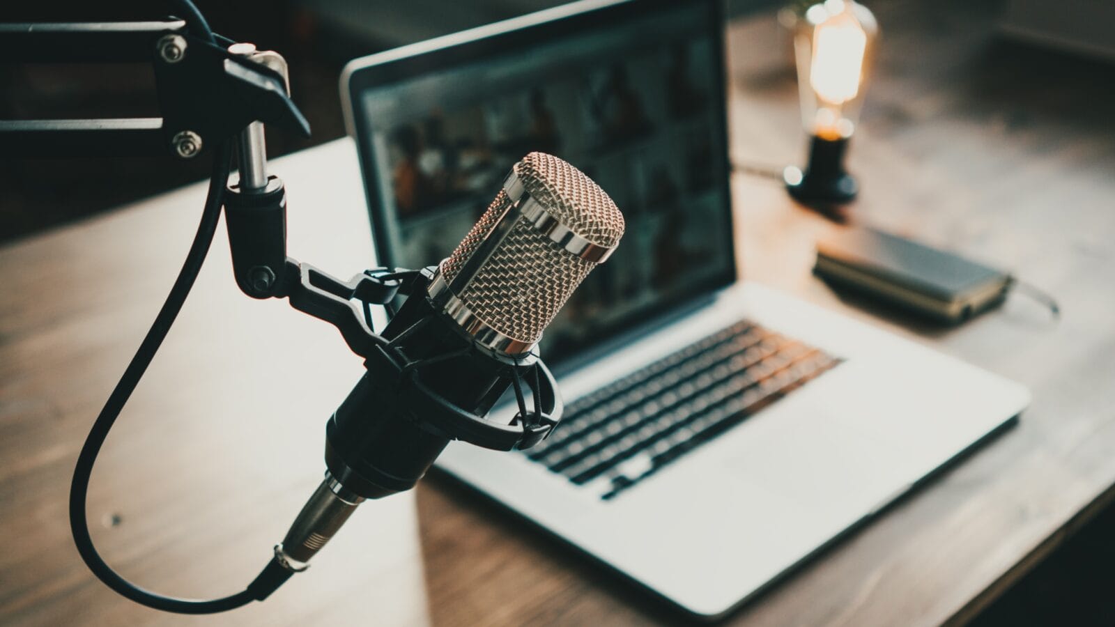 Microphone, laptop and on air lamp on a table.