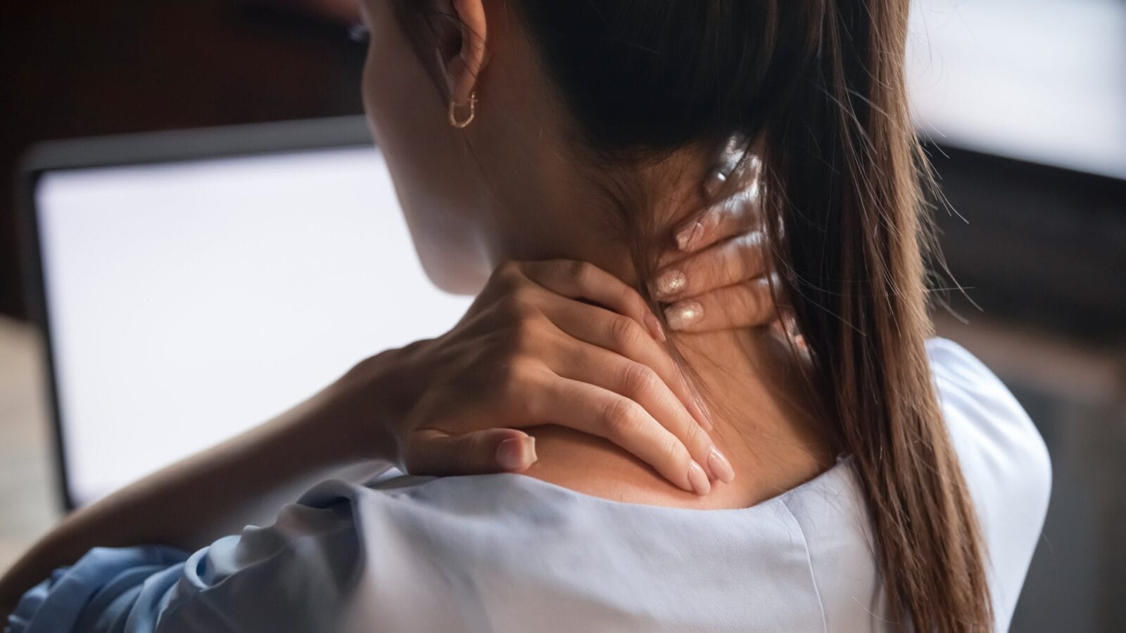 Tired woman massaging rubbing stiff sore neck