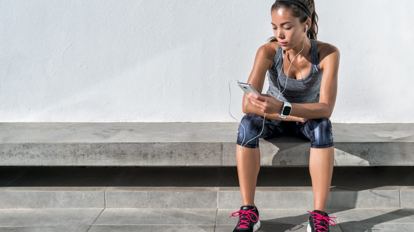 Athlete runner in sportswear relaxing sitting.
