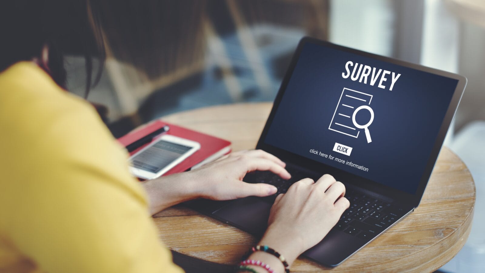A woman taking a survey on a laptop.