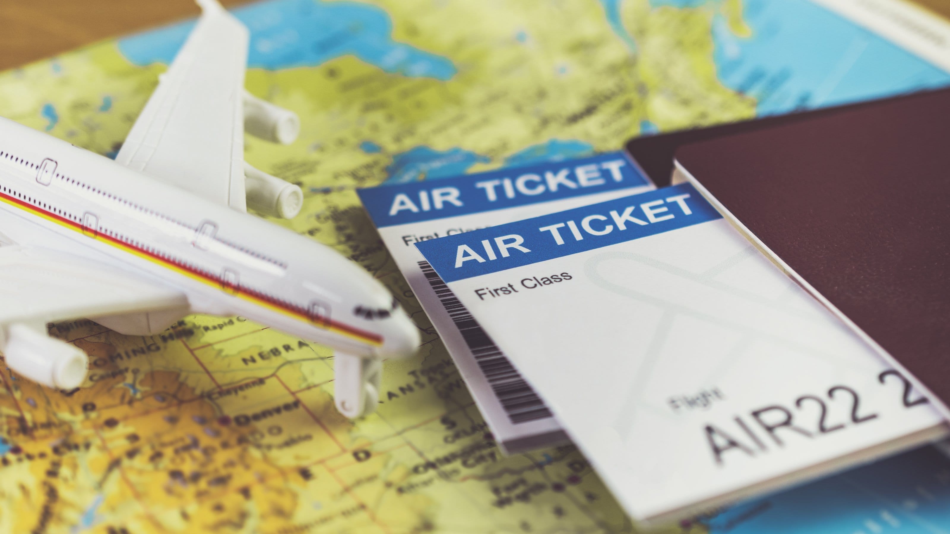 Air Ticket, plane and passports on a map.