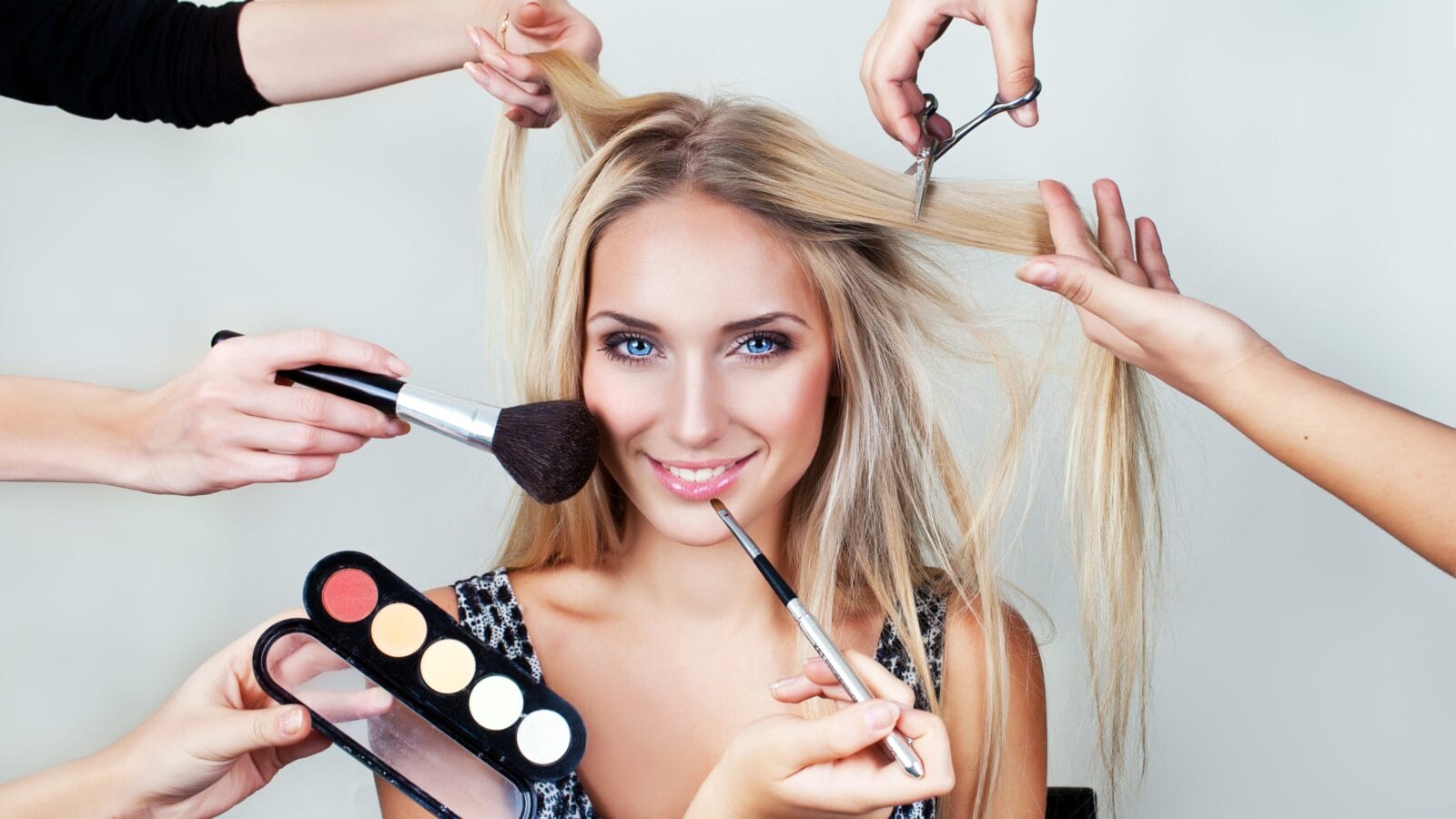 make up woman with many hands. makeup brushes, scissors, shadows
