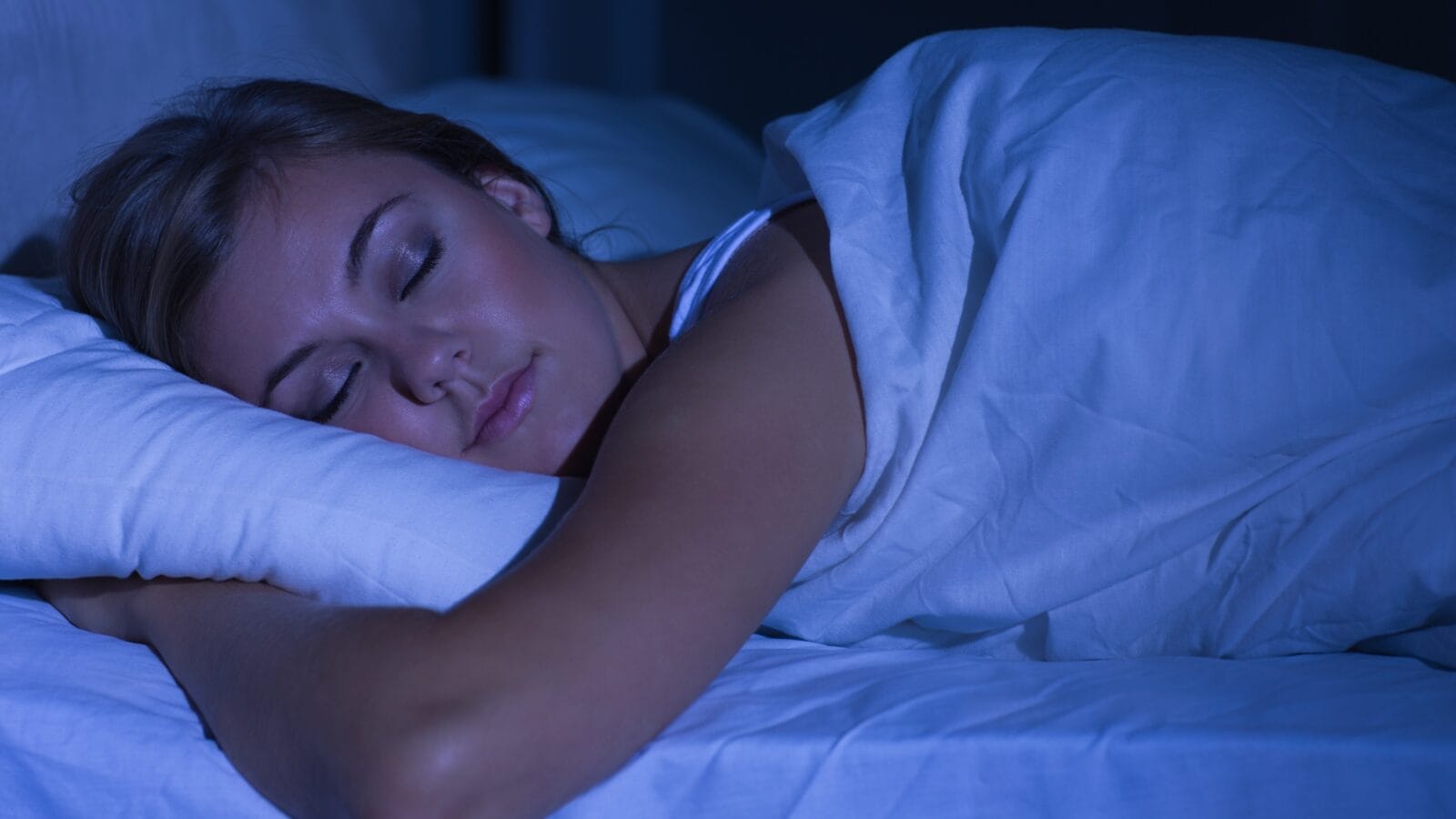 Woman sleeping at night in the bedroom