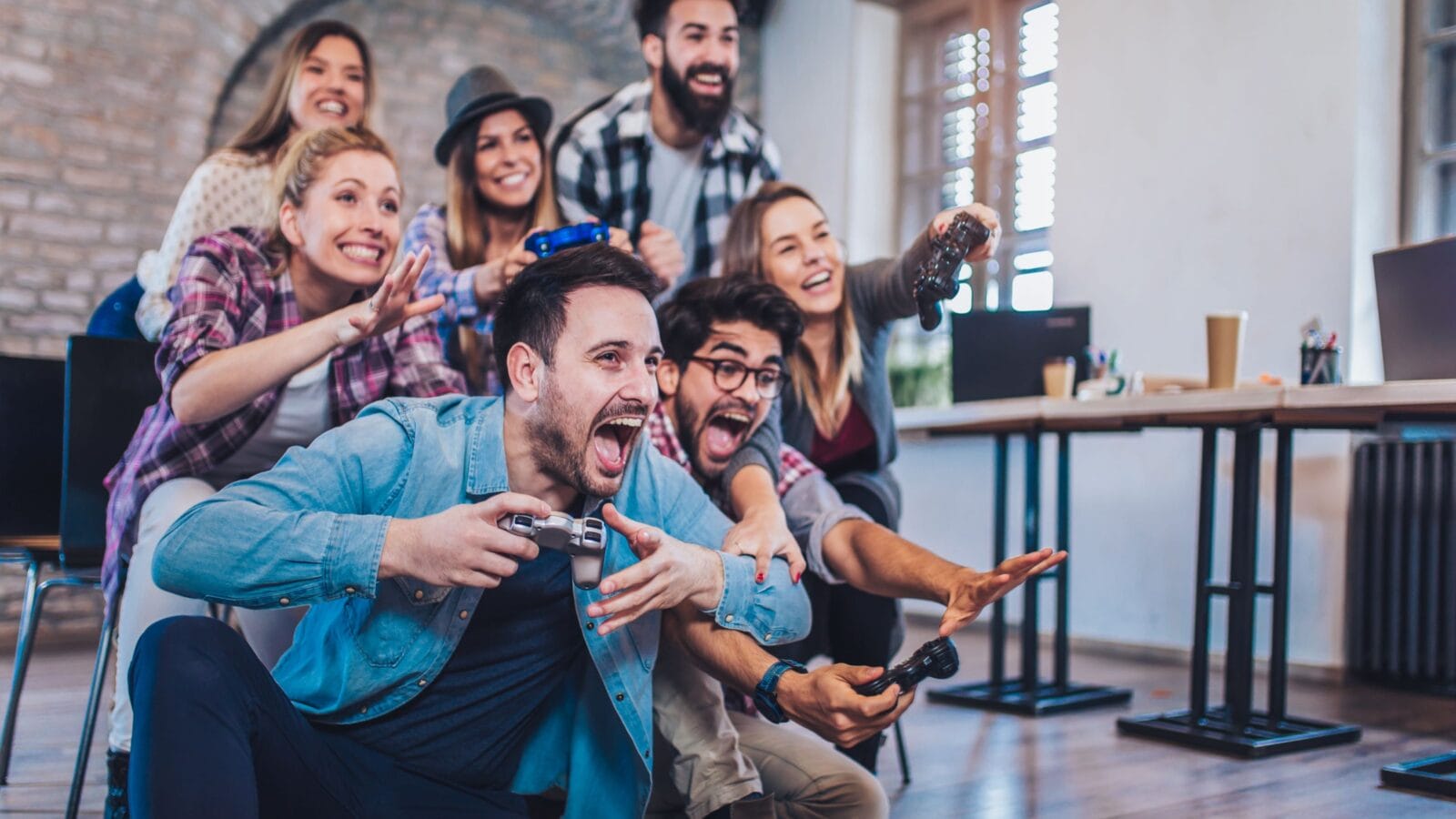 Coworkers playing video games in office