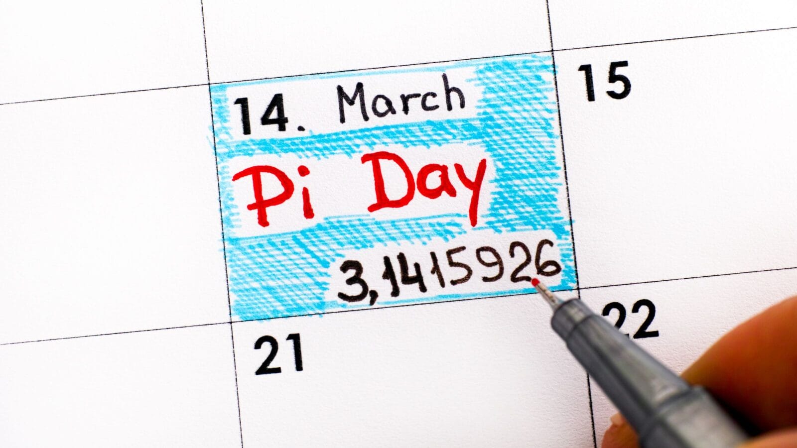 Woman fingers with pen writing reminder Pi Day in calendar