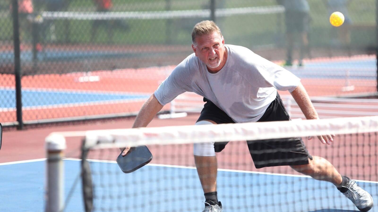 A man hits a pickleball