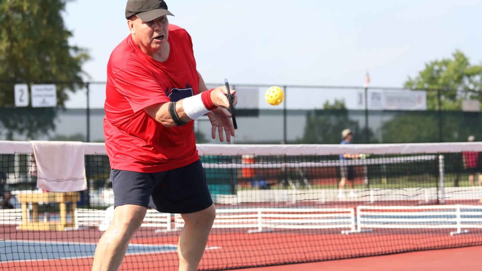 A senior competes in a pickleball tournament