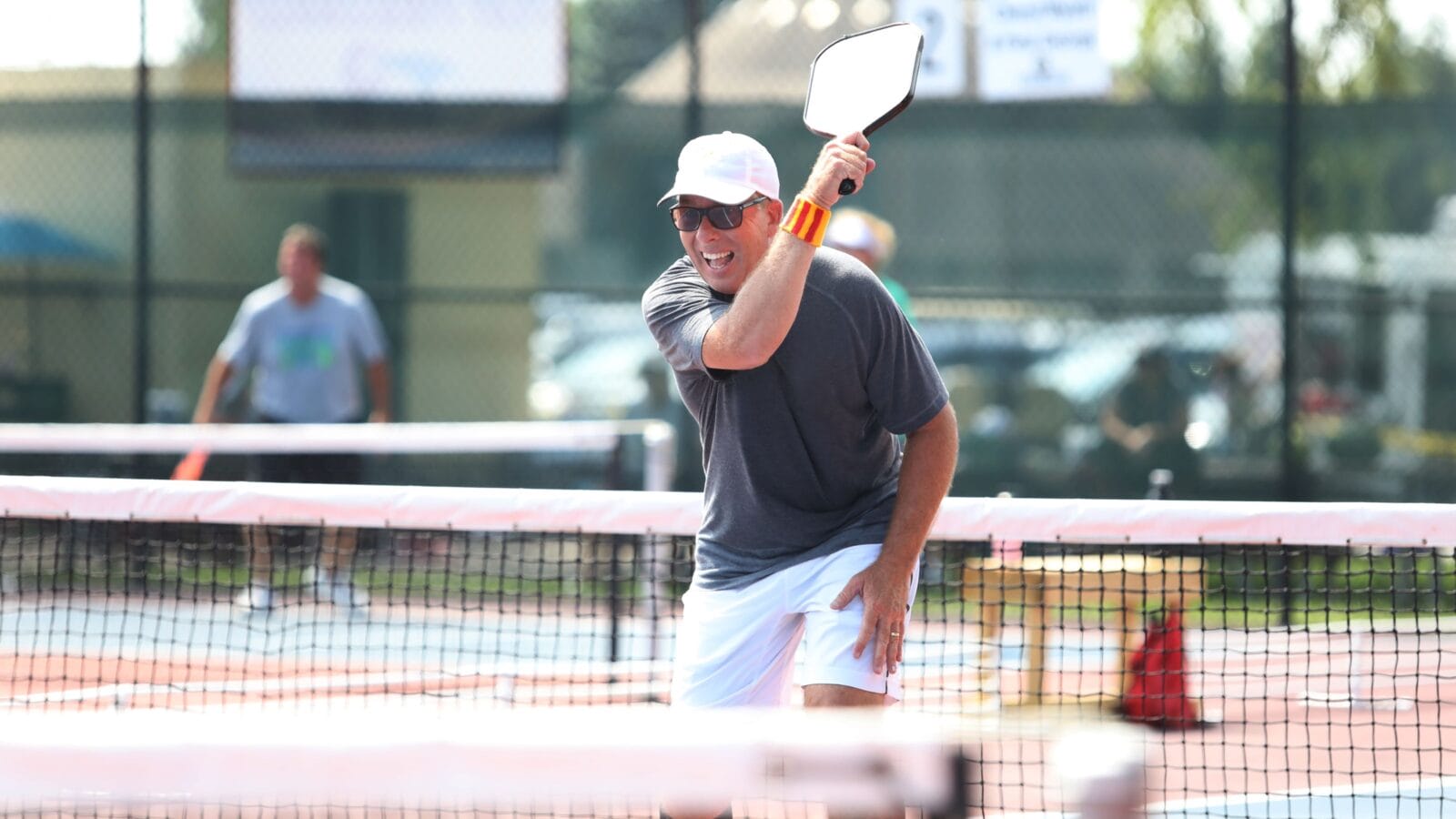 A tournament pickleball player follows through on a shot