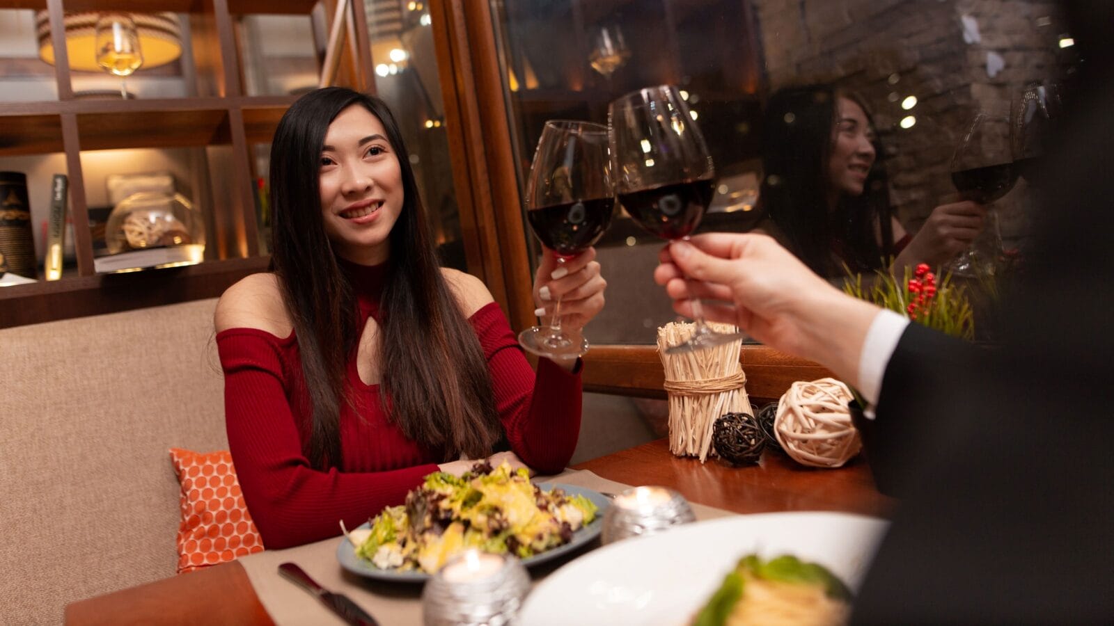 Romantic dinner in a restaurant with wine and salads