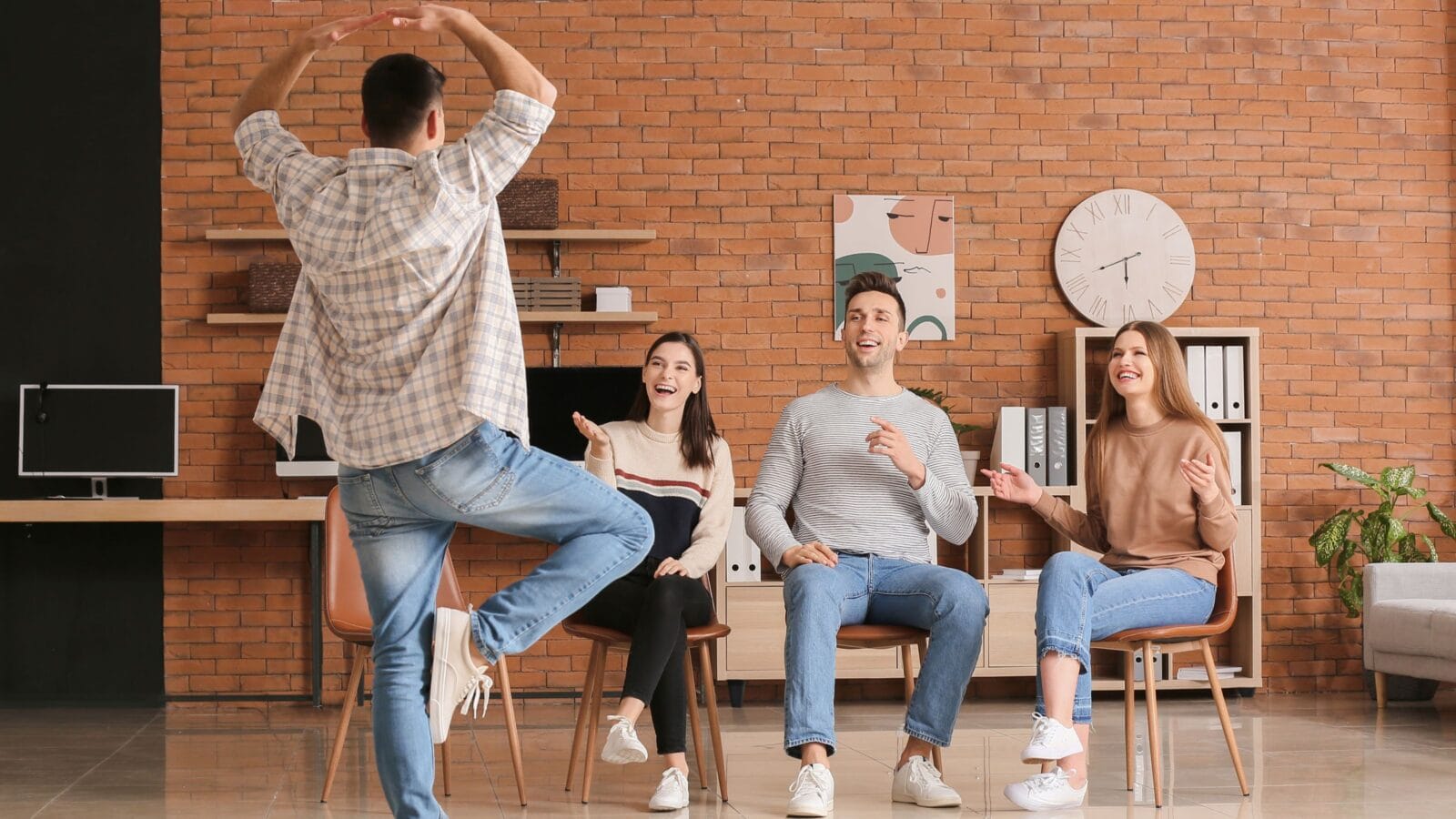 Team of business people playing charades in office