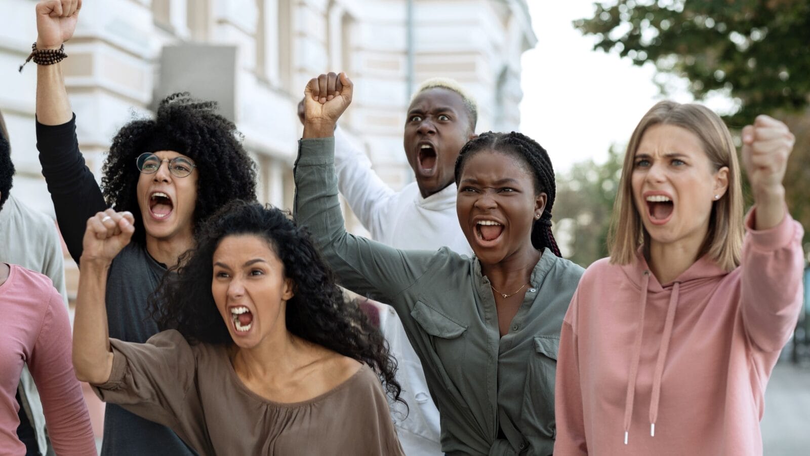 Closeup of emotional multiethnic group of strikers millennials men and women
