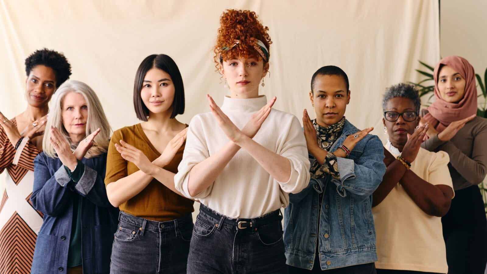Young white woman gesturing Break The Bias in support of International Women's Day with female friends