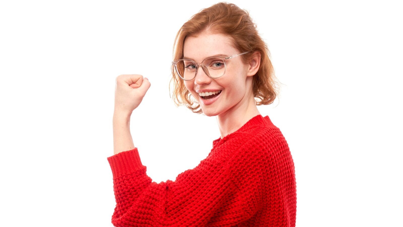 Portrait of young red-haired woman showing biceps, demonstrating girl power