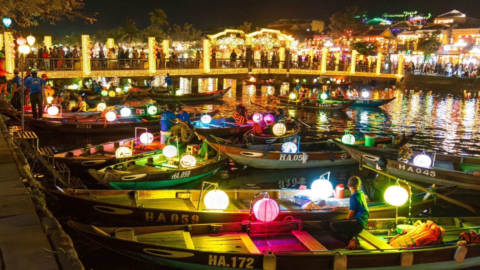 HOI AN, VIETNAM - MARCH 14, 2023: Night boat ride in Hoi An Ancient Town, lanterns, lights, tourists crowd Hoi An in Quang Nam province of Vietnam