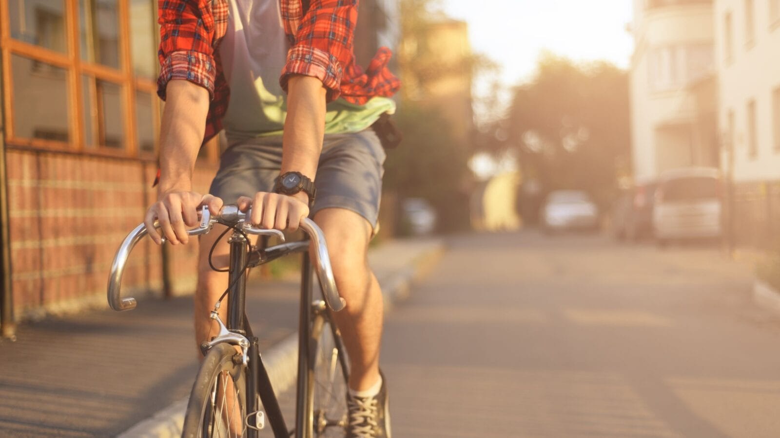 Close up hipster on bike in the city at sunset