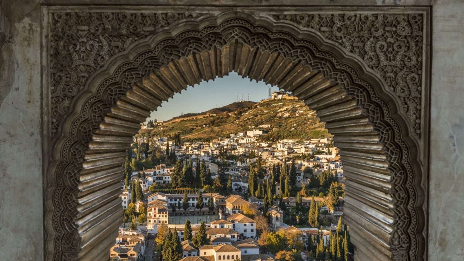 View of the Albayzin district of Granada, Spain, from a window in the Alhambra palace near sunset