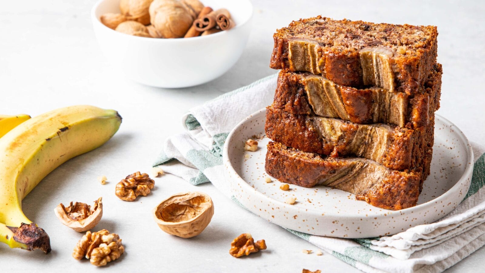Pieces of american homemade sliced banana bread with chopped walnuts, chocolate and cinnamon.