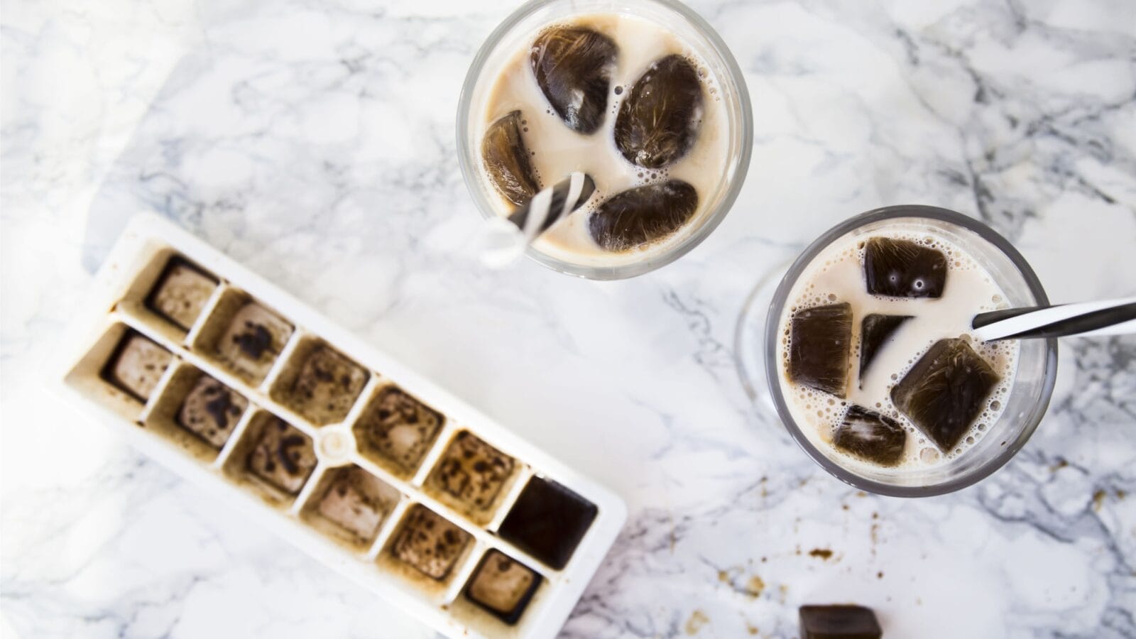 frozen coffee cubes with milk - cocktails on marble table