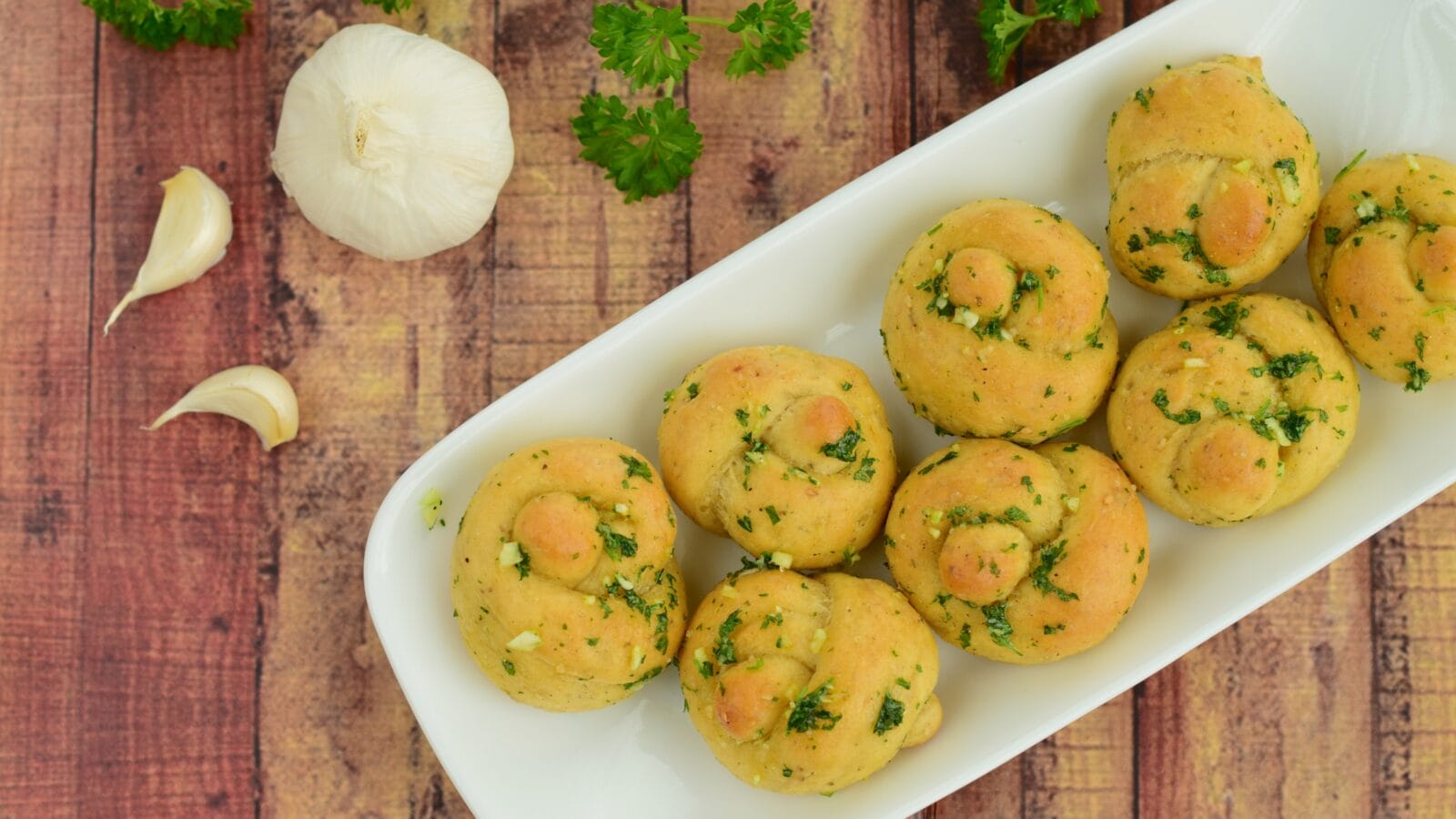 Garlic knots with coated with garlic parsley butter