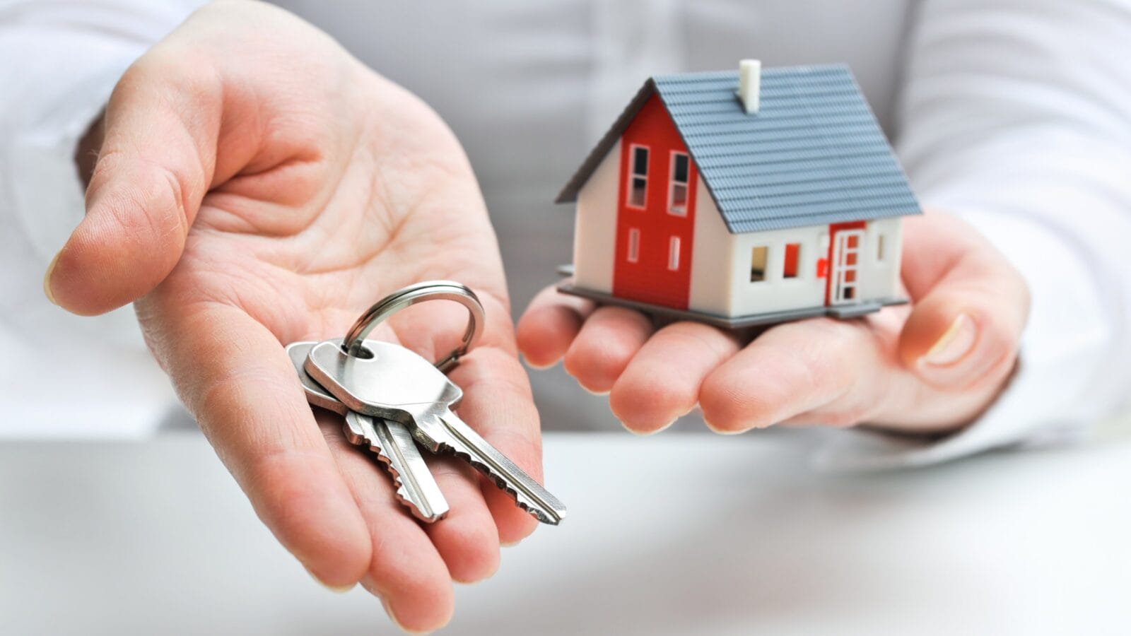 Real estate agent with house model and keys