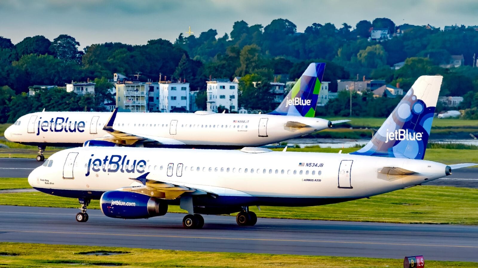 An Airbus A320 and A321 belonging to JetBlue Airways seen taxiing to the runway at Logan Airport in Boston Massachusetts.